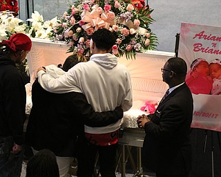      ROBERT  K. YOSAY | THE VINDICATOR.. Services for the five children killed Dec. 9 in a fire at their Parkcliffe Avenue home were held at New Bethel Baptist Church....Relatives hug as they say their goodbyes to the children