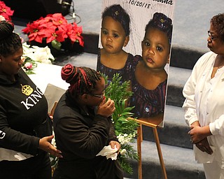      ROBERT  K. YOSAY | THE VINDICATOR.. Services for the five children killed Dec. 9 in a fire at their Parkcliffe Avenue home were held at New Bethel Baptist Church....Relatives hug as they say their goodbyes to the children