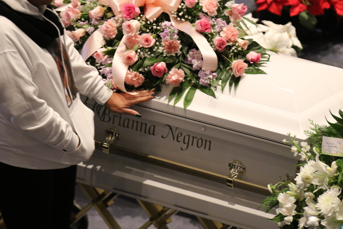      ROBERT  K. YOSAY | THE VINDICATOR.. Services for the five children killed Dec. 9 in a fire at their Parkcliffe Avenue home were held at New Bethel Baptist Church...A hand on the casket as a mourner says good bye to the twins.