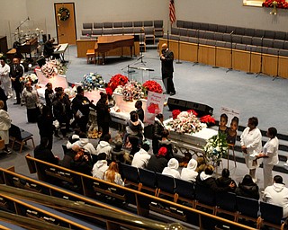      ROBERT  K. YOSAY | THE VINDICATOR.. Services for the five children killed Dec. 9 in a fire at their Parkcliffe Avenue home were held at New Bethel Baptist Church....Relatives hug as they say their goodbyes to the children