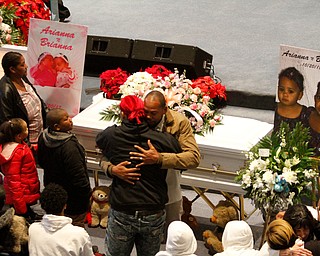      ROBERT  K. YOSAY | THE VINDICATOR.. Services for the five children killed Dec. 9 in a fire at their Parkcliffe Avenue home were held at New Bethel Baptist Church....Relatives hug as they say their goodbyes to the children