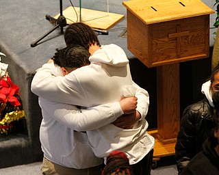      ROBERT  K. YOSAY | THE VINDICATOR.. Services for the five children killed Dec. 9 in a fire at their Parkcliffe Avenue home were held at New Bethel Baptist Church...Family members hug at the end of the service