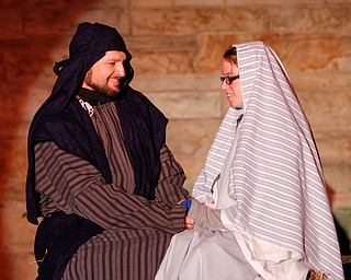 Joseph, portrayed by Brice Harris, and Mary, portrayed by Rachael Lanham, prepare for their baby to come during the Live Nativity at Zion Lutheran Church in Cornersburg on Sunday evening. EMILY MATTHEWS | THE VINDICATOR