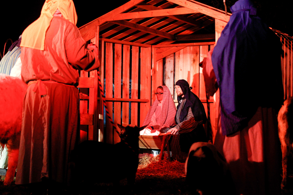 Mary, portrayed by Rachael Lanham, Joseph, portrayed by Brice Harris, kneel beside their baby Jesus during the Live Nativity at Zion Lutheran Church in Cornersburg on Sunday evening. EMILY MATTHEWS | THE VINDICATOR