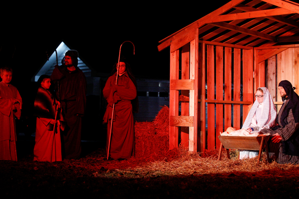 Mary, portrayed by Rachael Lanham, Joseph, portrayed by Brice Harris, kneel beside their baby Jesus during the Live Nativity at Zion Lutheran Church in Cornersburg on Sunday evening. EMILY MATTHEWS | THE VINDICATOR