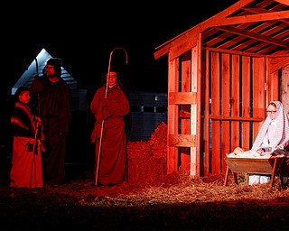 Mary, portrayed by Rachael Lanham, Joseph, portrayed by Brice Harris, kneel beside their baby Jesus during the Live Nativity at Zion Lutheran Church in Cornersburg on Sunday evening. EMILY MATTHEWS | THE VINDICATOR