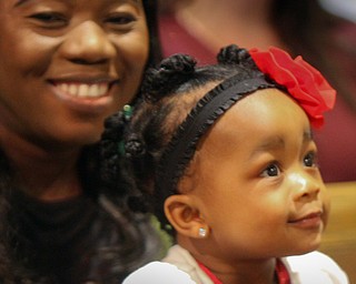 William D. Lewis The Vindicator Amelia Buie, 1, and her mother Hawa Buie were among those attending a Christmas Eve service at Trinity United Methodist Church in Youngstown. Rev Dawan Buie, husband and dad is a pastor at the church and  delivered the message during the ceremony. They are from Youngstown.