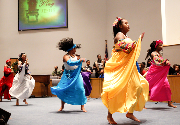 Dancers and drummers with the Harambee Youth Organization perform during a Kwanzaa celebration at New Bethel Baptist Church on Wednesday night. EMILY MATTHEWS | THE VINDICATOR
