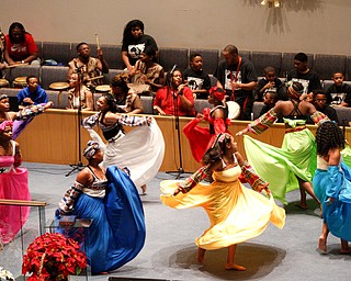 Dancers and drummers with the Harambee Youth Organization perform during a Kwanzaa celebration at New Bethel Baptist Church on Wednesday night. EMILY MATTHEWS | THE VINDICATOR