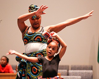 Skye Fowler, 5, front, and Jeylin Thomas, both of Youngstown, dance during a Kwanzaa celebration at New Bethel Baptist Church on Wednesday night. EMILY MATTHEWS | THE VINDICATOR