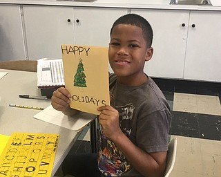 Neighbors | Submitted.Sixth-grader Stephon Chandler showed his finished card for the Stockings for Soldiers project during his art class. The card, and many like it from Boardman Center Middle School students, will be delivered to soldiers who are overseas for the holidays.