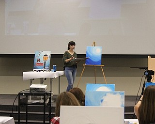 Neighbors | Abby Slanker.Mahoning County Career and Technical Center senior Jessica Arnott, president of the Creative Arts and Design class, instructed the participants of the Caffeinate and Paint in painting a winter scene on Dec. 5.