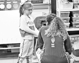 Neighbors | Jessica Harker.Hoops Green pulled volunteer student Mackenzie Bond from Karen DiVito's second grade classroom who she nick named "little hoops".