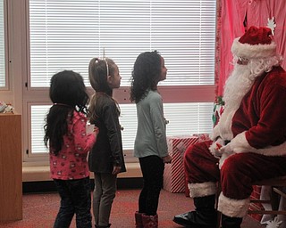 Neighbors | Jessica Harker.Kindergarten students at Austintown Elementary School lined up to tell Santa Claus what they want for Christmas Dec. 19 when he visited the school.
