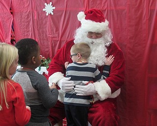Neighbors | Jessica Harker.Students greeted Santa at Austintown Elementary School Dec. 19, telling him what they want for Christmas and posing for photos with them.