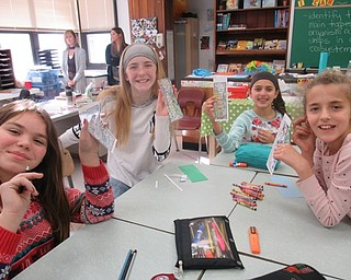 Neighbors | Jessica Harker .Fifth-grade students, from left, Allison Bowser, Kaelyn DeBlois, Kaitlyn Casanova and Victoria Bagshaw showed off the booksmarks they decorated to be donated to local nursing homes.