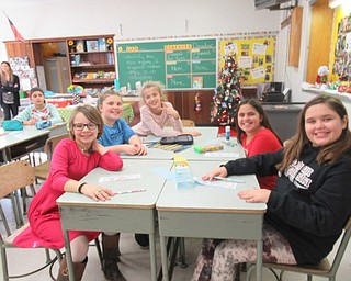 Neighbors | Jessica Harker .Boardman Center Middle School students, from left, Lilly Andrei, Olivia Combis, Christina Coutris and Dimitra Coutris worked to create bookmarks to donate to local nursing homes on Dec. 18.