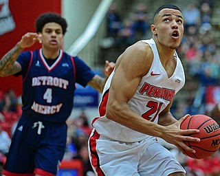 YOUNGSTOWN, OHIO - DECEMBER 28, 2018: Youngstown State's Noe Anabir goes to the basket after getting behind Detroit Mercy's Jacob Holland during the first half of their game, Saturday afternoon at Beeghly Center. Detroit Mercy won 78-66. DAVID DERMER | THE VINDICATOR
