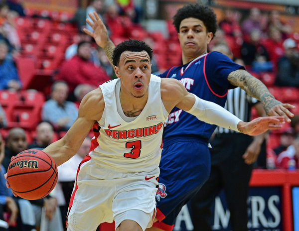 YOUNGSTOWN, OHIO - DECEMBER 28, 2018: Youngstown State's Darius Quisenberry drives on Detroit Mercy's Jacob Holland during the first half of their game, Saturday afternoon at Beeghly Center. Detroit Mercy won 78-66. DAVID DERMER | THE VINDICATOR