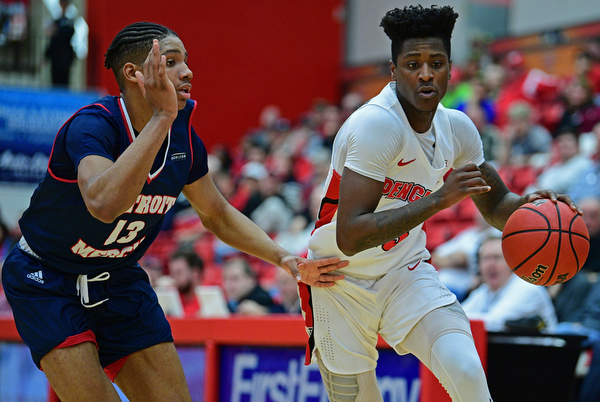 YOUNGSTOWN, OHIO - DECEMBER 28, 2018: Youngstown State's Donel Cathcart III drives on Detroit Mercy's Chris Brandon during the first half of their game, Saturday afternoon at Beeghly Center. Detroit Mercy won 78-66. DAVID DERMER | THE VINDICATOR