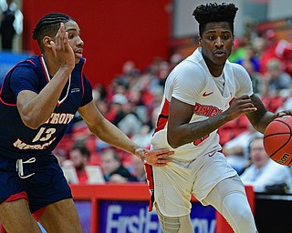 YOUNGSTOWN, OHIO - DECEMBER 28, 2018: Youngstown State's Donel Cathcart III drives on Detroit Mercy's Chris Brandon during the first half of their game, Saturday afternoon at Beeghly Center. Detroit Mercy won 78-66. DAVID DERMER | THE VINDICATOR