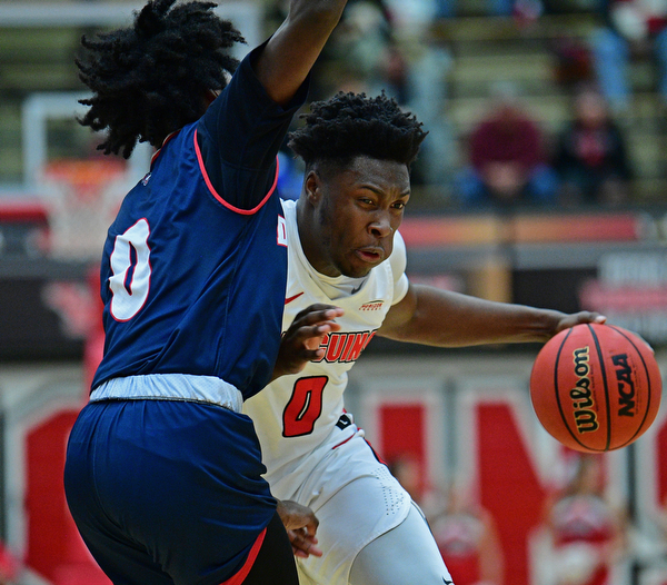 YOUNGSTOWN, OHIO - DECEMBER 28, 2018: Youngstown State's Antwan Maxwell, Jr. drives on Detroit Mercy's Antoine Davis during the first half of their game, Saturday afternoon at Beeghly Center. Detroit Mercy won 78-66. DAVID DERMER | THE VINDICATOR