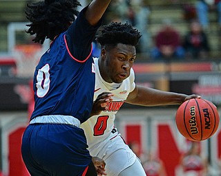 YOUNGSTOWN, OHIO - DECEMBER 28, 2018: Youngstown State's Antwan Maxwell, Jr. drives on Detroit Mercy's Antoine Davis during the first half of their game, Saturday afternoon at Beeghly Center. Detroit Mercy won 78-66. DAVID DERMER | THE VINDICATOR