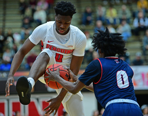 YOUNGSTOWN, OHIO - DECEMBER 28, 2018: Youngstown State's Antwan Maxwell, Jr. has the ball taken away from him by Detroit Mercy's Antoine Davis as he goes to the basket during the first half of their game, Saturday afternoon at Beeghly Center. Detroit Mercy won 78-66. DAVID DERMER | THE VINDICATOR