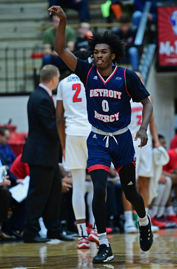 YOUNGSTOWN, OHIO - DECEMBER 28, 2018: Detroit Mercy's Antoine Davis celebrates after hitting a three point shot int he face of Youngstown State's Jelani Simmons during the first half of their game, Saturday afternoon at Beeghly Center. Detroit Mercy won 78-66. DAVID DERMER | THE VINDICATOR