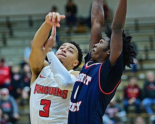 YOUNGSTOWN, OHIO - DECEMBER 28, 2018: Youngstown State's Darius Quisenberry looks to put up a shot hole being pressured by Detroit Mercy's Antoine Davis during the first half of their game, Saturday afternoon at Beeghly Center. Detroit Mercy won 78-66. DAVID DERMER | THE VINDICATOR