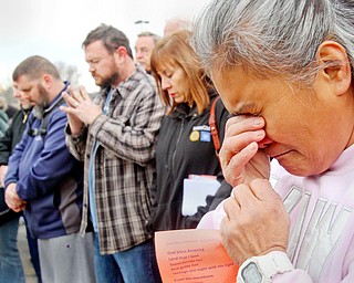 William D. Lewis The Vindicator Venus Walker, a GM employee with 12 years at the Lordstown plant from Warren,prays during a vigil outside the Lordstown GM plant 11-29-18. About 200 workers attended the event.