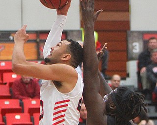 William D. Lewis The Vindicator  YSU's Oalamide Pederson(23) brings down a rebound past Oakland's Xavier Hill-Mais(14) during 12-302018 action at YSU.