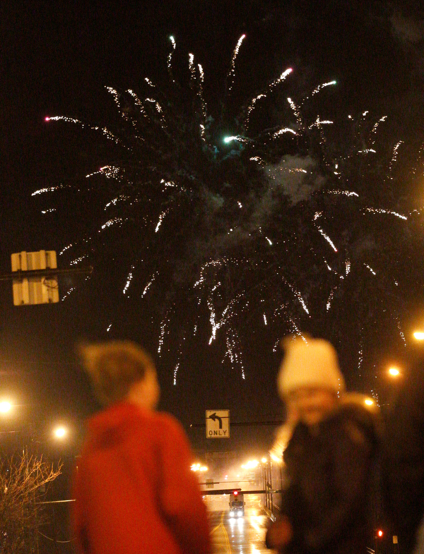 People watch fireworks during First Night Youngstown Monday night. EMILY MATTHEWS | THE VINDICATOR