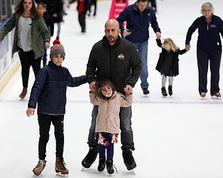 A.J. Atway, 9, left, and Leyann Atway, 4, ice skate with their dad Said Atway, all of Columbus, in Covelli Centre during First Night Youngstown Monday night. EMILY MATTHEWS | THE VINDICATOR