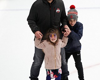 Said Atway, of Columbus, ice skates with his kids Leyann Atway, 4, and A.J. Atway, 9, in Covelli Centre during First Night Youngstown Monday night. EMILY MATTHEWS | THE VINDICATOR