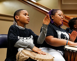Jumane McKinney, 10, of Cleveland, left, and Effie Dawson, 14, of Liberty, drum with Harambee inside 20 Federal Place during First Night Youngstown Monday night. EMILY MATTHEWS | THE VINDICATOR