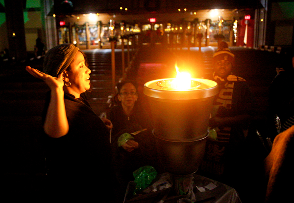 Jaietta Jackson, of Youngstown, puts her name into the Goblet of Fire at the Harry Potter Experience inside Trinity United Methodist Church during First Night Youngstown Monday night. EMILY MATTHEWS | THE VINDICATOR