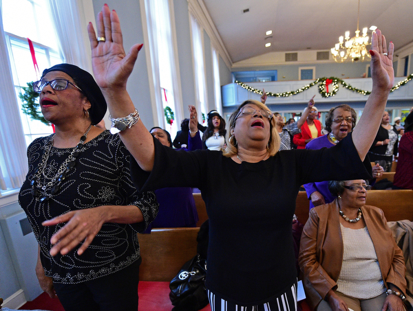 YOUNGSTOWN, OHIO - JANUARY 1, 2019: Carol Griffin from Youngstown, left, and Linda Jenkins from Youngstown, right, sing, Tuesday morning during the Community Emancipation Proclamation & Installation of Officers Service at Calvary Baptist Church. DAVID DERMER | THE VINDICATOR