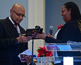 YOUNGSTOWN, OHIO - JANUARY 1, 2019: Dr. Robin Woodberry, right, presents Rev. Kenneth L. Simon with the Powell Heritage Award, Tuesday morning during the Community Emancipation Proclamation & Installation of Officers Service at Calvary Baptist Church. DAVID DERMER | THE VINDICATOR