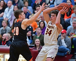 CANFIELD, OHIO - JANUARY 2, 2019: South Range's Chris Brown looks to pass while being pressured by Springfield's Beau Brungard during the second half of their game, Wednesday night at South Range High School. DAVID DERMER | THE VINDICATOR