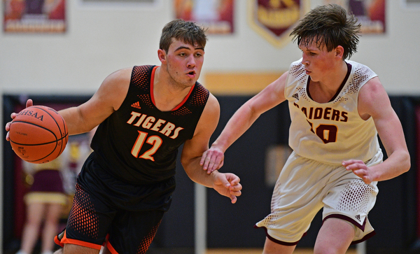 CANFIELD, OHIO - JANUARY 2, 2019: Springfield's Shane Eynon drives on South Range's Chris Brooks during the second half of their game, Wednesday night at South Range High School. DAVID DERMER | THE VINDICATOR