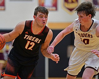 CANFIELD, OHIO - JANUARY 2, 2019: Springfield's Shane Eynon drives on South Range's Chris Brooks during the second half of their game, Wednesday night at South Range High School. DAVID DERMER | THE VINDICATOR