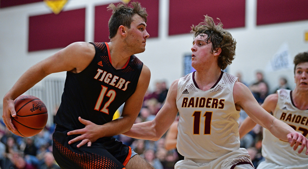 CANFIELD, OHIO - JANUARY 2, 2019: Springfield's Shane Eynon goes to the basket against South Range's Dante DiGaetano during the second half of their game, Wednesday night at South Range High School. DAVID DERMER | THE VINDICATOR