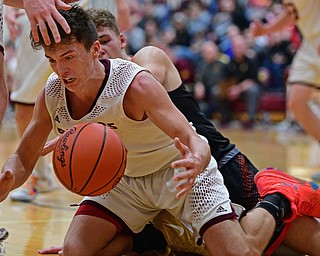 CANFIELD, OHIO - JANUARY 2, 2019: South Range's Jaxon Anderson reaches for the loose ball while being pressured from behind by South Range's Clay Medvec during the second half of their game, Wednesday night at South Range High School. DAVID DERMER | THE VINDICATOR