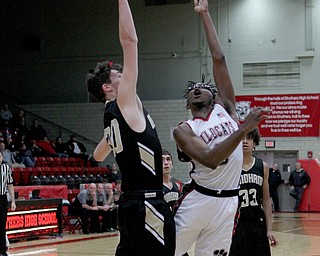 Kevin Traylor (3) of Struthers is closely defended by Bailey Rutherford (30) of Windham as he puts up a layup during Wednesday nights matchup at Struthers High School.  Dustin Livesay  |  The Vindicator  1/2/19  Struthers