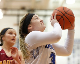 Poland's Mia Gajdos looks towards the net while Mooney's Alaina Scavina watches behind her during their game at Poland on Thursday night. EMILY MATTHEWS | THE VINDICATOR