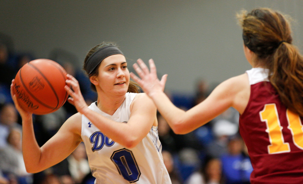 Poland's Elena Cammack looks to pass the ball while Mooney's Carolyn Kay tries to block her during their game at Poland on Thursday night. EMILY MATTHEWS | THE VINDICATOR