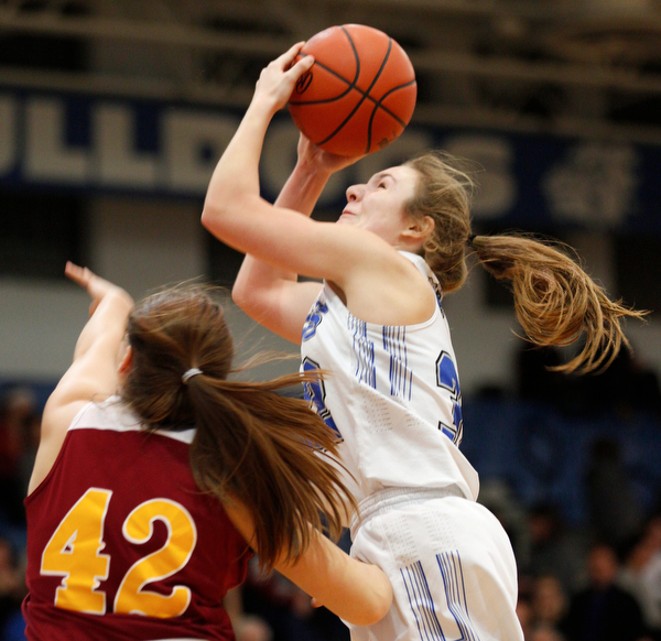 Poland's Morgan Kluchar grabs a rebound as Mooney's Conchetta Rinaldi reaches for it during their game at Poland on Thursday night. EMILY MATTHEWS | THE VINDICATOR
