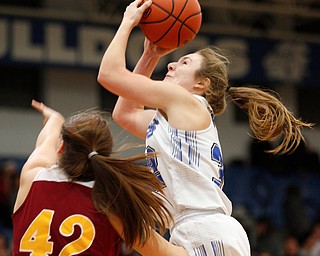 Poland's Morgan Kluchar grabs a rebound as Mooney's Conchetta Rinaldi reaches for it during their game at Poland on Thursday night. EMILY MATTHEWS | THE VINDICATOR