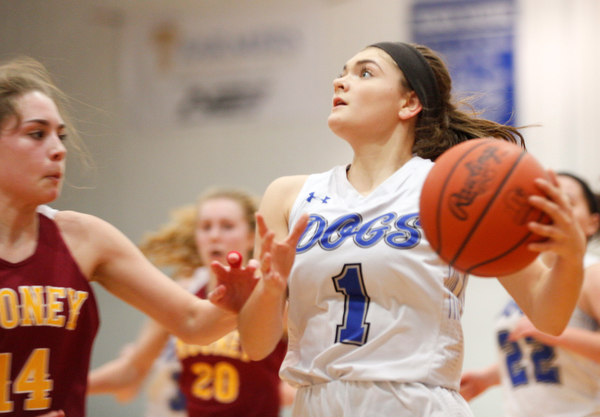 Poland's Brooke Bobbey looks towards the net while Mooney's Camden Hergenrother tries to block her during their game at Poland on Thursday night. EMILY MATTHEWS | THE VINDICATOR